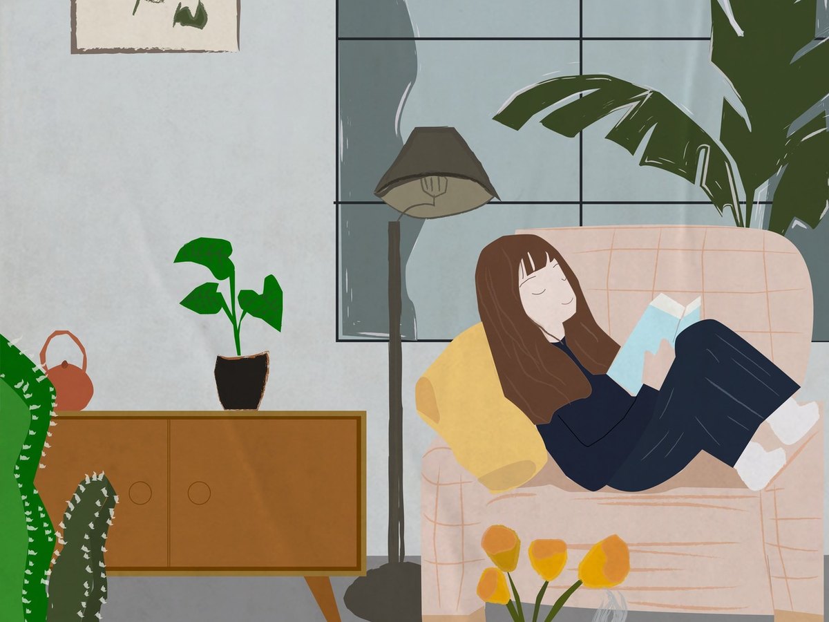 Racó de lectura amb sofà, llum natural i plantes · Alex Interiors